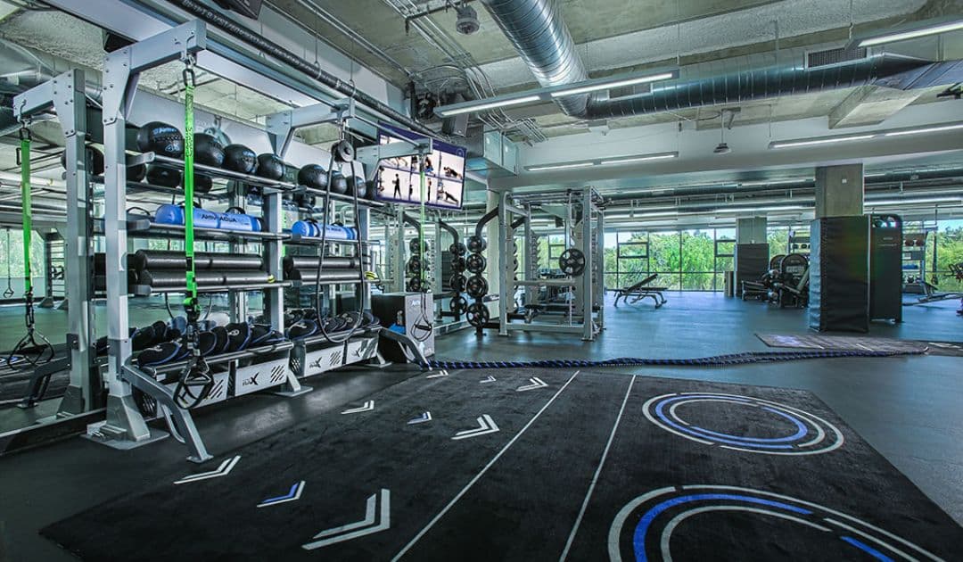 Corporate gym with digital exercise guidance. 